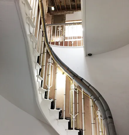 a beautiful staircase with wooden railing